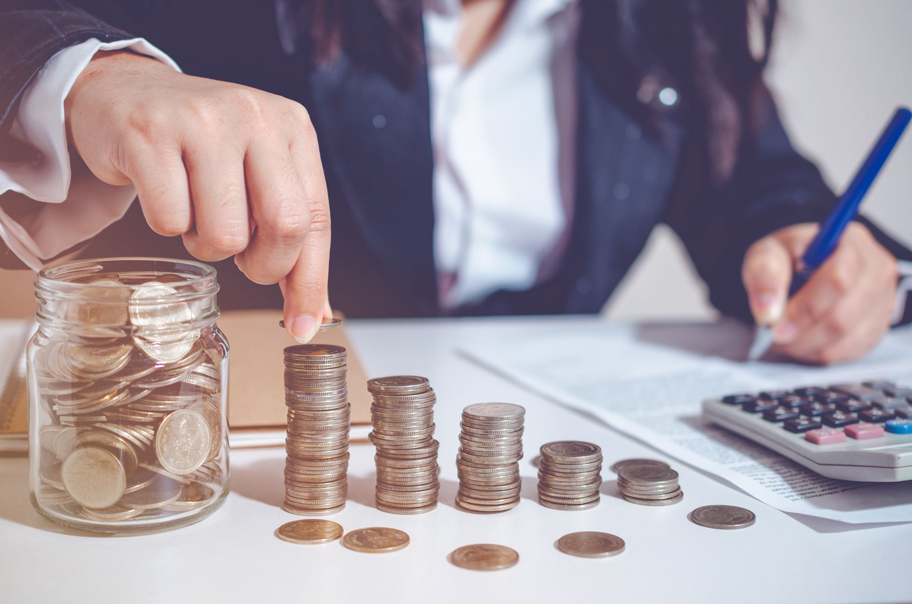 Man stacking coins in a graph shape